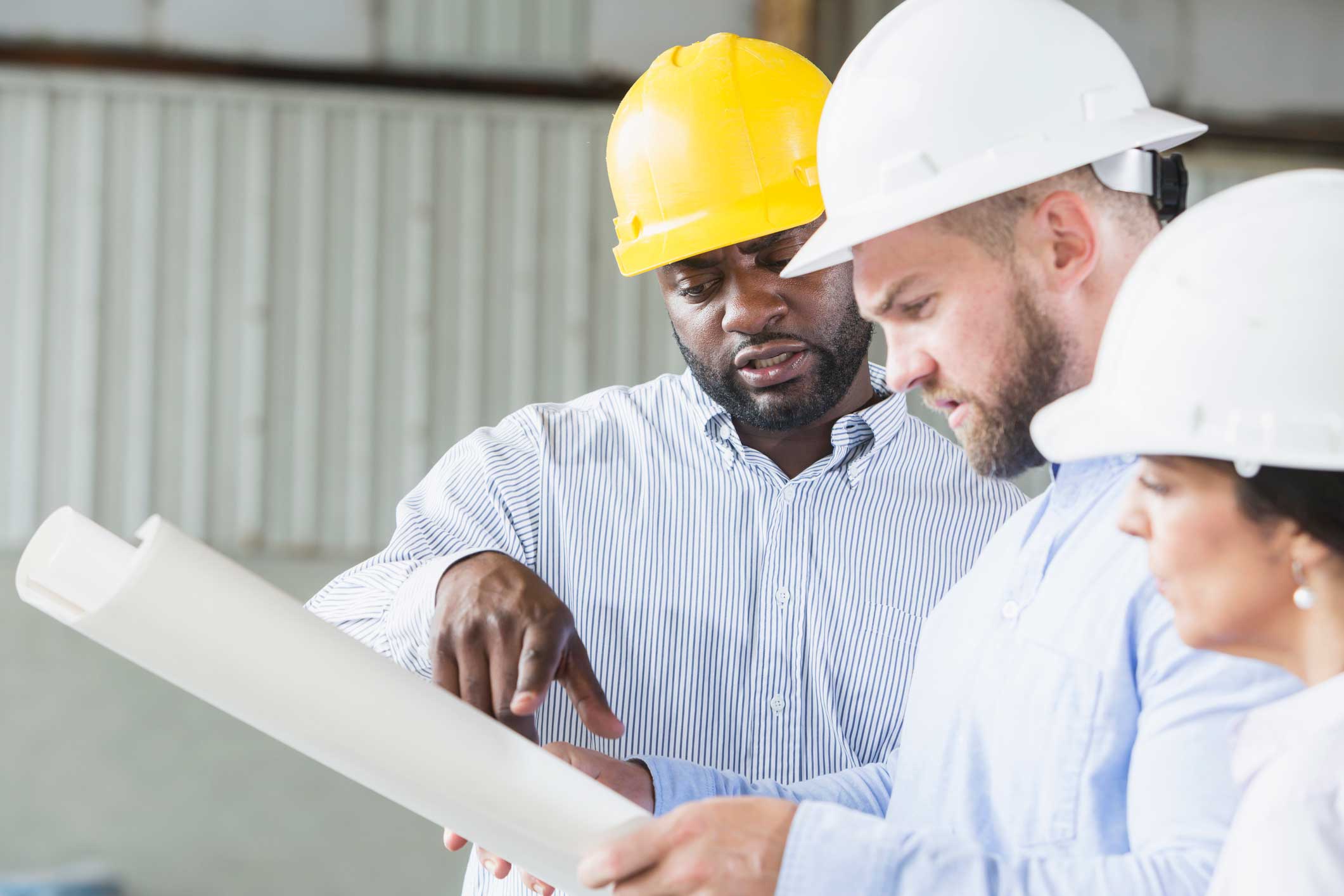 group of construction workers looking at blueprints